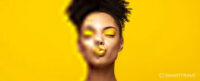 Woman pouting with yellow lipstick and eye shadow against a yellow background. Half of image is high resolution, the other half is pixellated. Used to illustrate the article: The problem with Google’s SR3 image-upscaling technology by SmartFrame Technologies