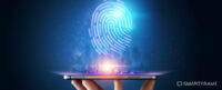Human hand holding an up-facing tablet projecting a CGI fingerprint from it's screen. Image used to illustrate the SmartFrame blog: Browser fingerprinting: Everything you need to know