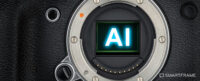 Front-on view of camera body without a lens attached with the letters ‘AI’ glowing in blue where the sensor should be. Used to illustrate the SmartFrame article” ‘AI image generators: everything you need to know’