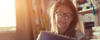 Woman with tablet reading the SmartFrame blog